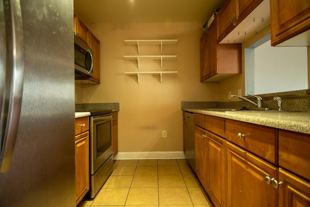 kitchen featuring baseboards, open shelves, light tile patterned flooring, appliances with stainless steel finishes, and a sink