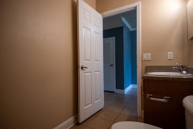 bathroom featuring tile patterned floors, baseboards, a sink, and toilet