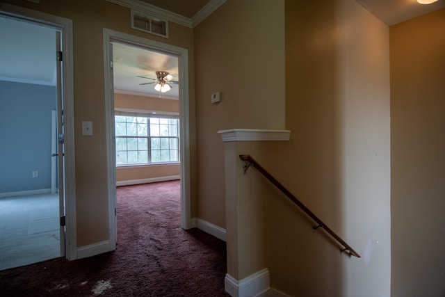 hall featuring baseboards, an upstairs landing, crown molding, carpet floors, and visible vents