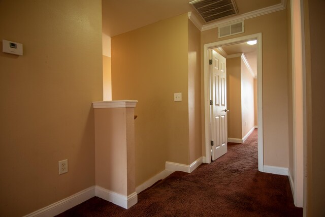 hall featuring ornamental molding, visible vents, baseboards, and carpet floors