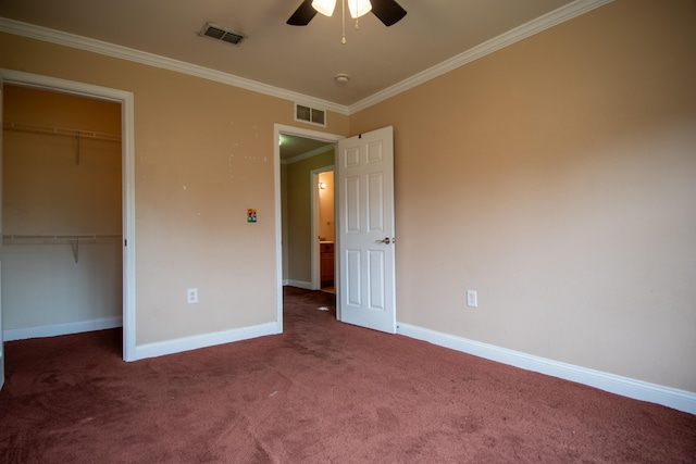 unfurnished bedroom featuring visible vents, baseboards, crown molding, and carpet floors