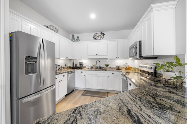 25 S Wildflower Dr Unit 224, Santa Rosa Beach, FL 32459 - kitchen with white cabinets, stone counters, backsplash, and appliances with stainless steel finishes