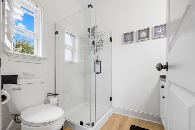 25 S Wildflower Dr Unit 224, Santa Rosa Beach, FL 32459 - bathroom featuring a stall shower, toilet, wood finished floors, and baseboards