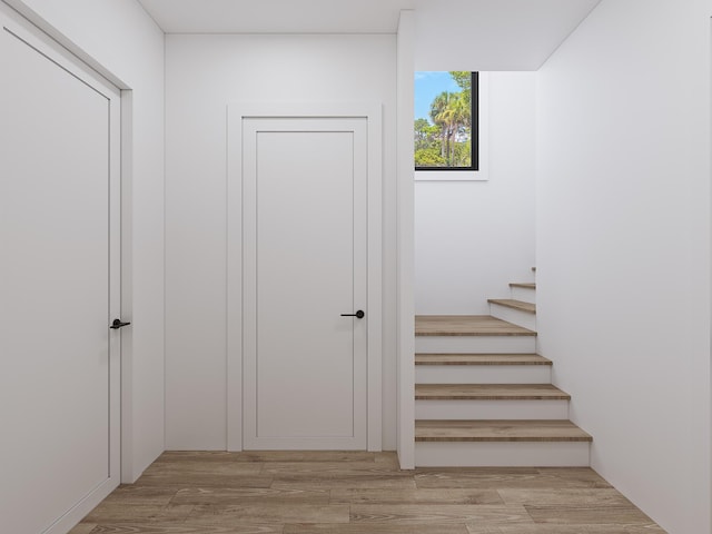 stairway with wood finished floors