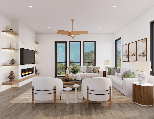 living room with light wood-style floors, a fireplace, and recessed lighting