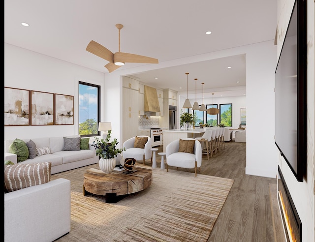 living room featuring a ceiling fan, recessed lighting, and wood finished floors