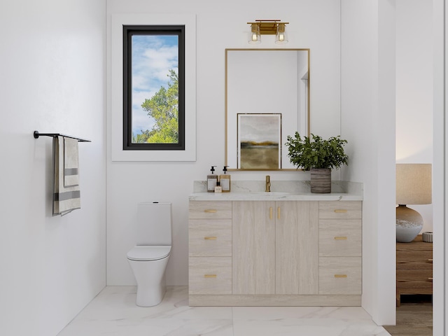 bathroom featuring marble finish floor, toilet, and vanity