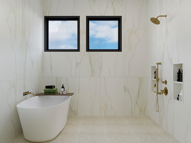 full bathroom featuring a freestanding tub and a marble finish shower