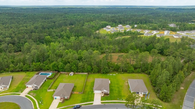 drone / aerial view with a residential view and a view of trees