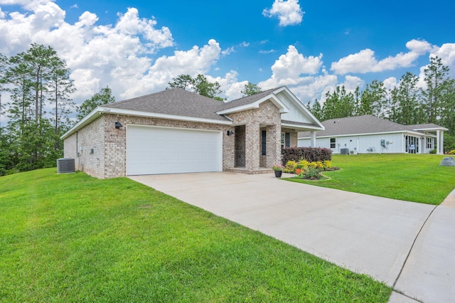 view of front of house featuring an attached garage, central AC, brick siding, a front yard, and driveway