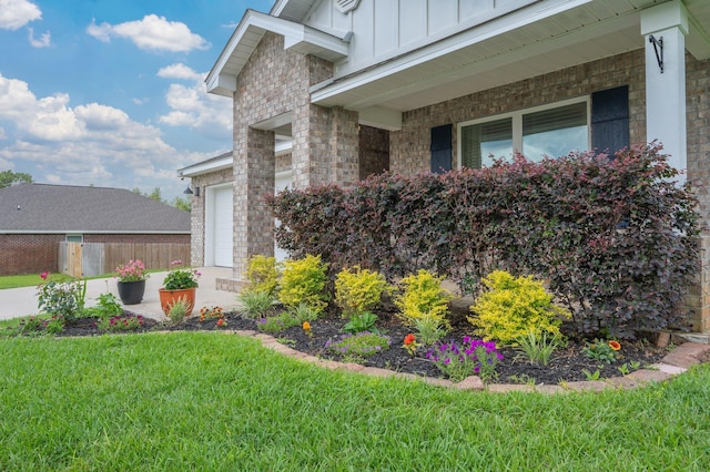 3060 Brandon Dunes Ln, Laurel Hill, FL 32567 - view of home's exterior featuring board and batten siding, covered porch, an attached garage, and brick siding