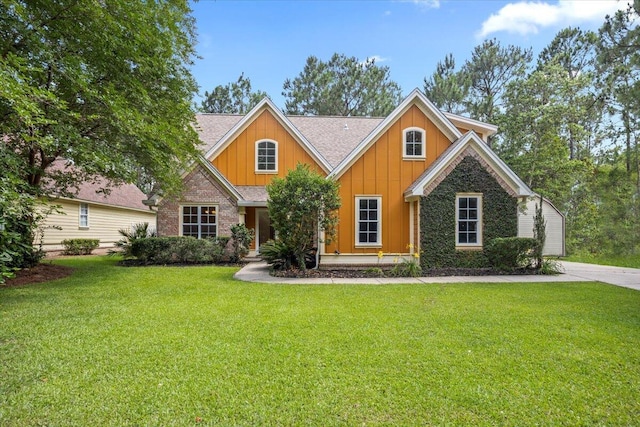 51 Village Ct, Freeport, FL 32439 - craftsman-style house featuring board and batten siding, a front lawn, and a shingled roof