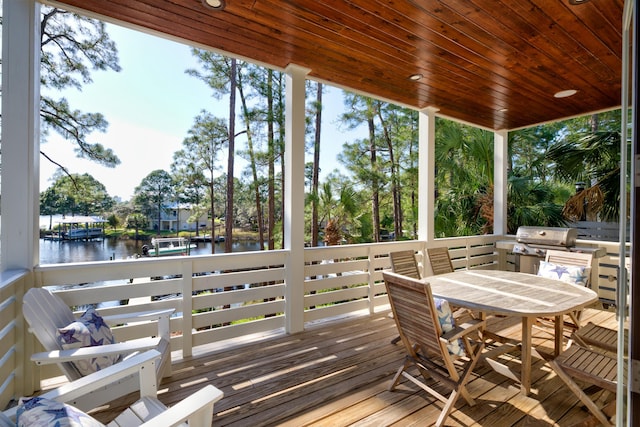 sunroom / solarium featuring a water view