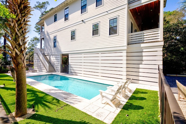 pool with stairs and a lawn