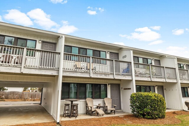 3605 E County Highway 30a Unit 236, Santa Rosa Beach, FL 32459 - view of building exterior with fence