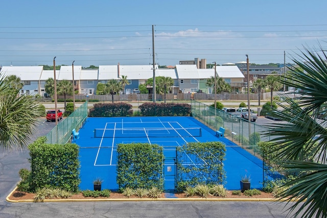 view of sport court featuring fence