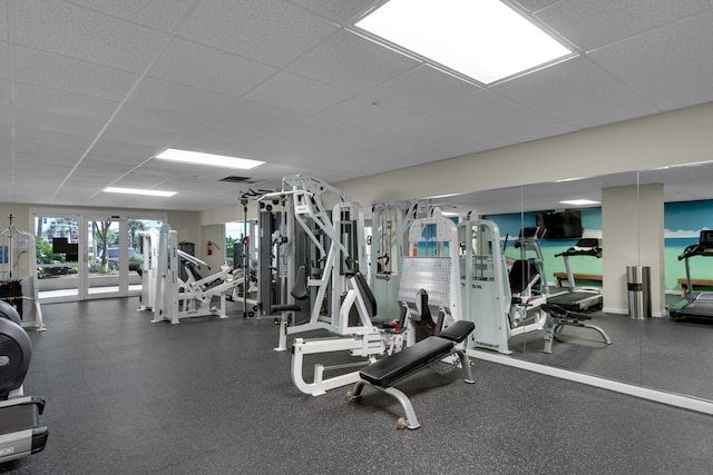 workout area featuring visible vents and a paneled ceiling