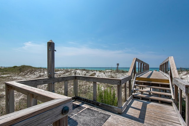 exterior space with a water view and a beach view