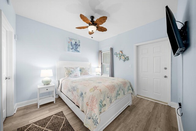 9860 S Thomas Dr Unit 501, Panama City Beach, FL 32408 - bedroom featuring baseboards, a ceiling fan, and light wood finished floors