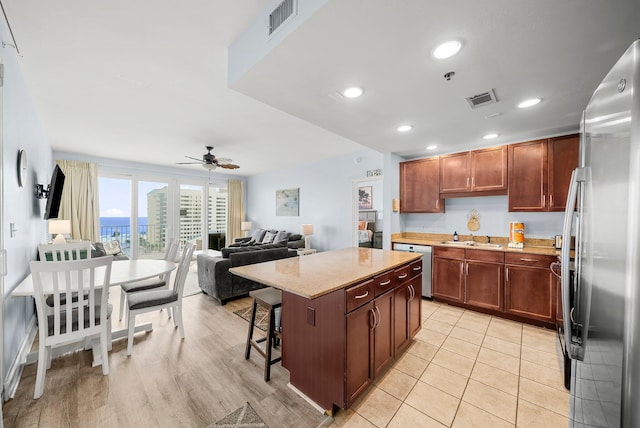 9860 S Thomas Dr Unit 501, Panama City Beach, FL 32408 - kitchen featuring a ceiling fan, a kitchen island, appliances with stainless steel finishes, and visible vents