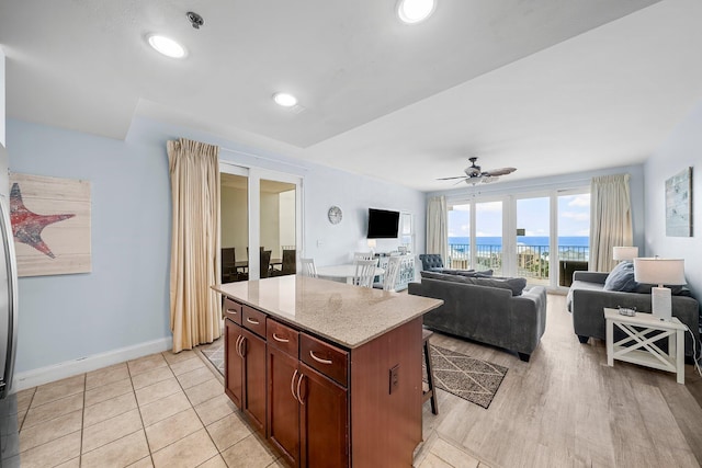 9860 S Thomas Dr Unit 501, Panama City Beach, FL 32408 - kitchen with recessed lighting, a center island, baseboards, a breakfast bar, and a ceiling fan