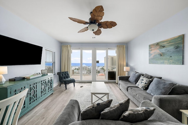 9860 S Thomas Dr Unit 501, Panama City Beach, FL 32408 - living area with baseboards, wood finished floors, and a ceiling fan
