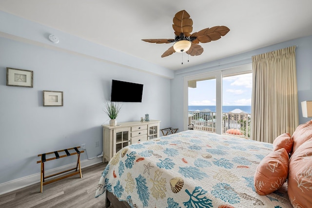 9860 S Thomas Dr Unit 501, Panama City Beach, FL 32408 - bedroom with baseboards, access to exterior, light wood-style floors, and ceiling fan