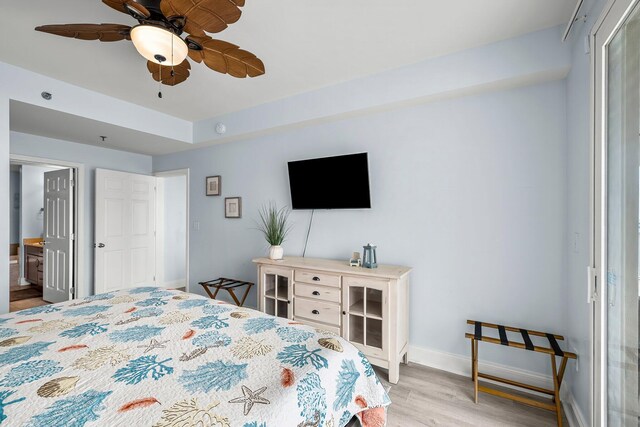 9860 S Thomas Dr Unit 501, Panama City Beach, FL 32408 - bedroom with a ceiling fan, ensuite bathroom, baseboards, and light wood finished floors