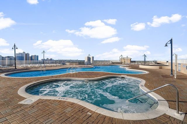 9860 S Thomas Dr Unit 501, Panama City Beach, FL 32408 - pool with a patio area, a view of city, and a hot tub