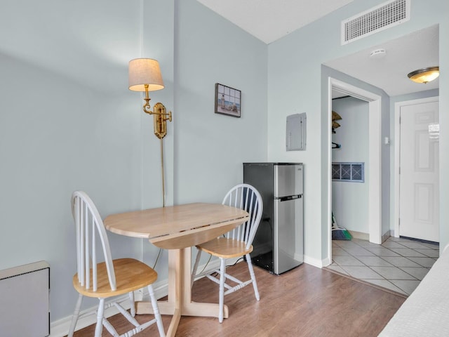 dining area featuring wood finished floors, baseboards, and visible vents