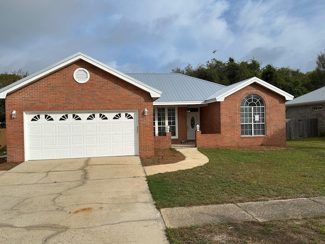 287 Stahlman Ave, Destin, FL 32541 - single story home featuring concrete driveway, an attached garage, a front yard, brick siding, and metal roof