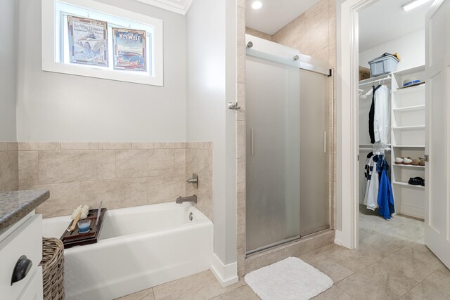 862 Bay Grove Rd, Freeport, FL 32439 - bathroom featuring a shower stall, a garden tub, a walk in closet, and tile patterned flooring