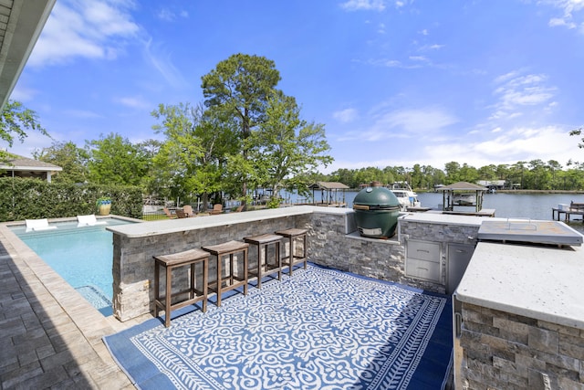 862 Bay Grove Rd, Freeport, FL 32439 - view of patio with an outdoor kitchen, a fenced in pool, area for grilling, exterior bar, and a water view