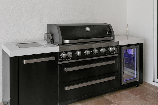 interior details with beverage cooler and electric range