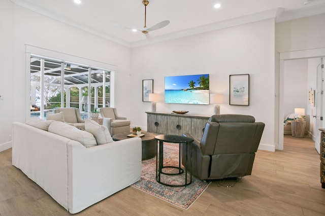 living area with recessed lighting, ornamental molding, baseboards, a ceiling fan, and wood finished floors
