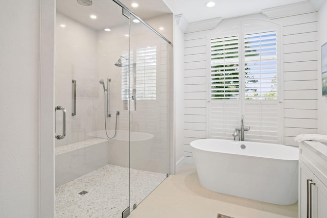 bathroom with a freestanding tub, a stall shower, and recessed lighting