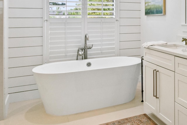 full bath with a soaking tub and vanity