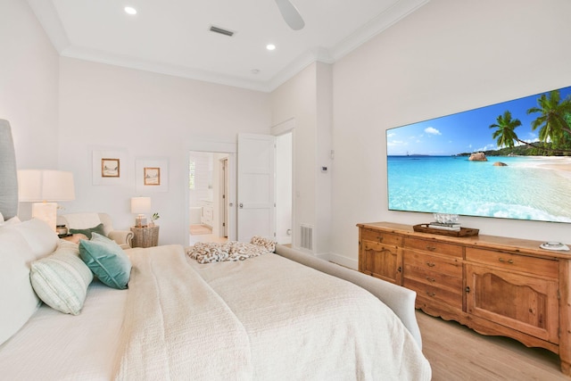 bedroom featuring light wood-type flooring, ornamental molding, connected bathroom, and visible vents