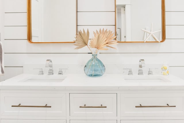 full bath featuring double vanity and a sink