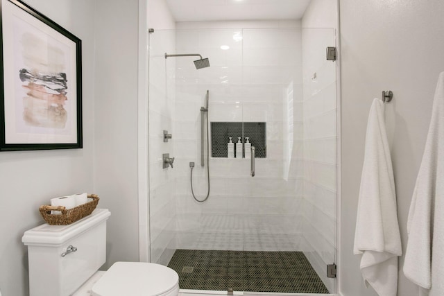 full bath with toilet and a stall shower
