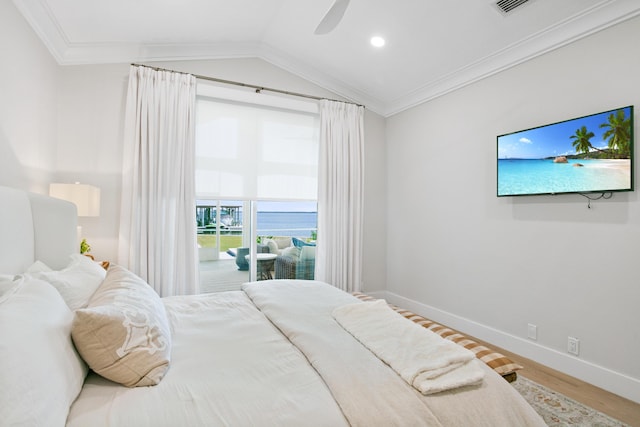 bedroom with baseboards, vaulted ceiling, crown molding, and wood finished floors