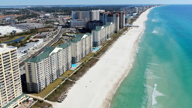 bird's eye view featuring a view of the beach, a city view, and a water view