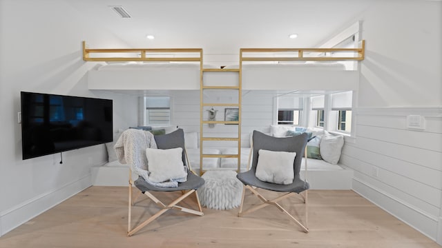 sitting room featuring wood finished floors, recessed lighting, and visible vents