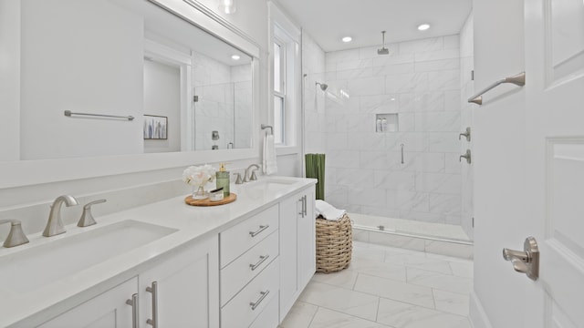 bathroom with a shower stall, recessed lighting, marble finish floor, and a sink