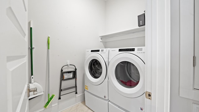 laundry area featuring separate washer and dryer, laundry area, and baseboards