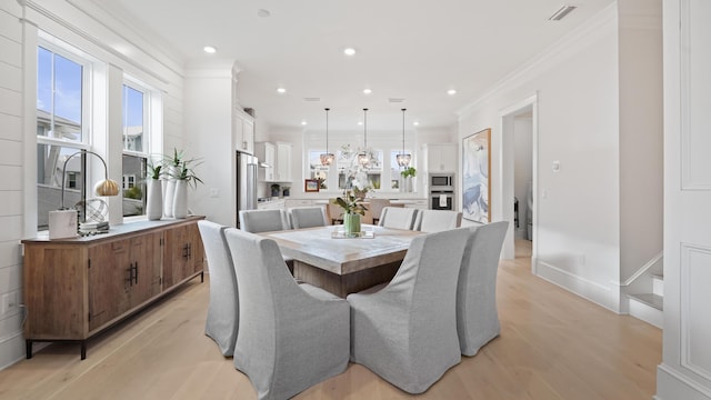 dining space with light wood-type flooring, recessed lighting, and ornamental molding