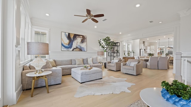 living room with recessed lighting, ceiling fan, light wood-style floors, and crown molding