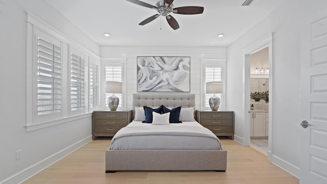 bedroom with ensuite bath, baseboards, ceiling fan, and light wood-type flooring