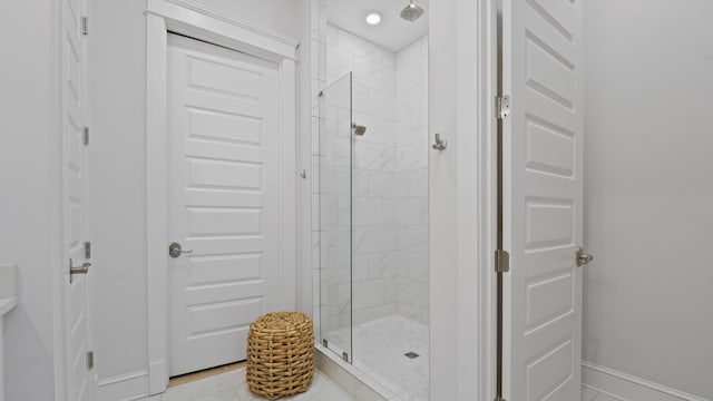 full bath featuring baseboards and a stall shower