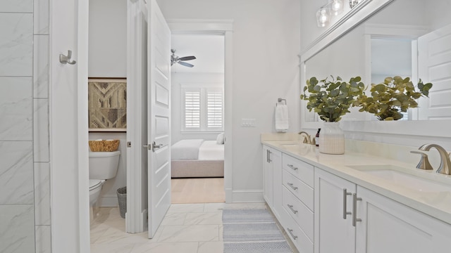 bathroom featuring a sink, toilet, marble finish floor, double vanity, and ensuite bathroom